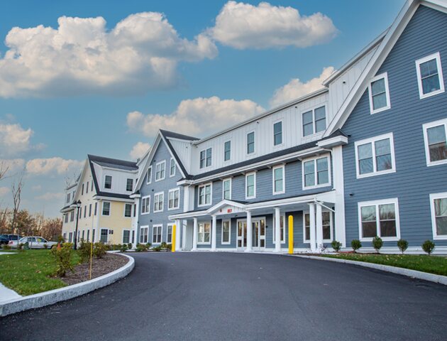 Front entrance and driveway of The Coolidge at Sudbury apartment building